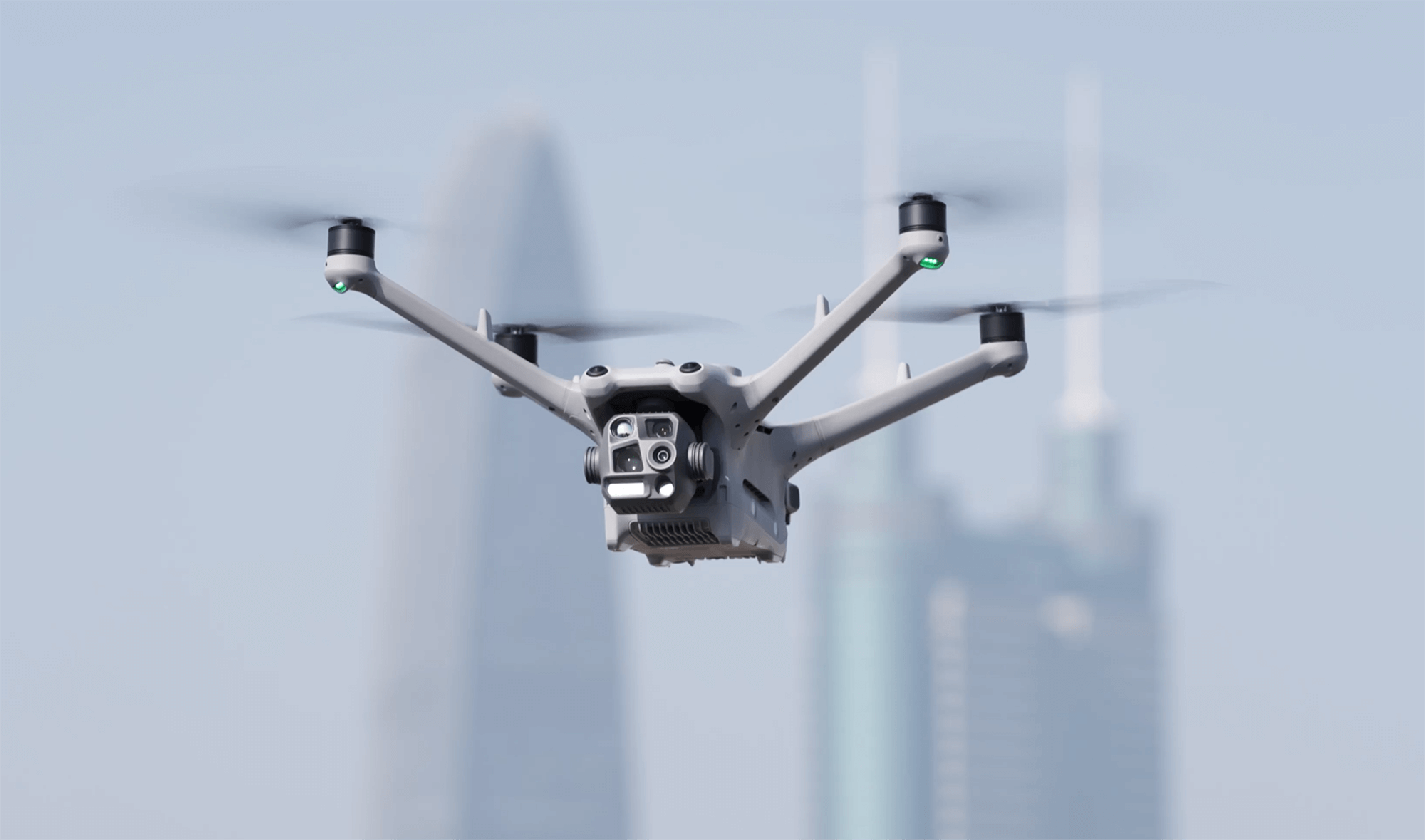 Professional industrial UAV with multi-camera payload against urban skyline